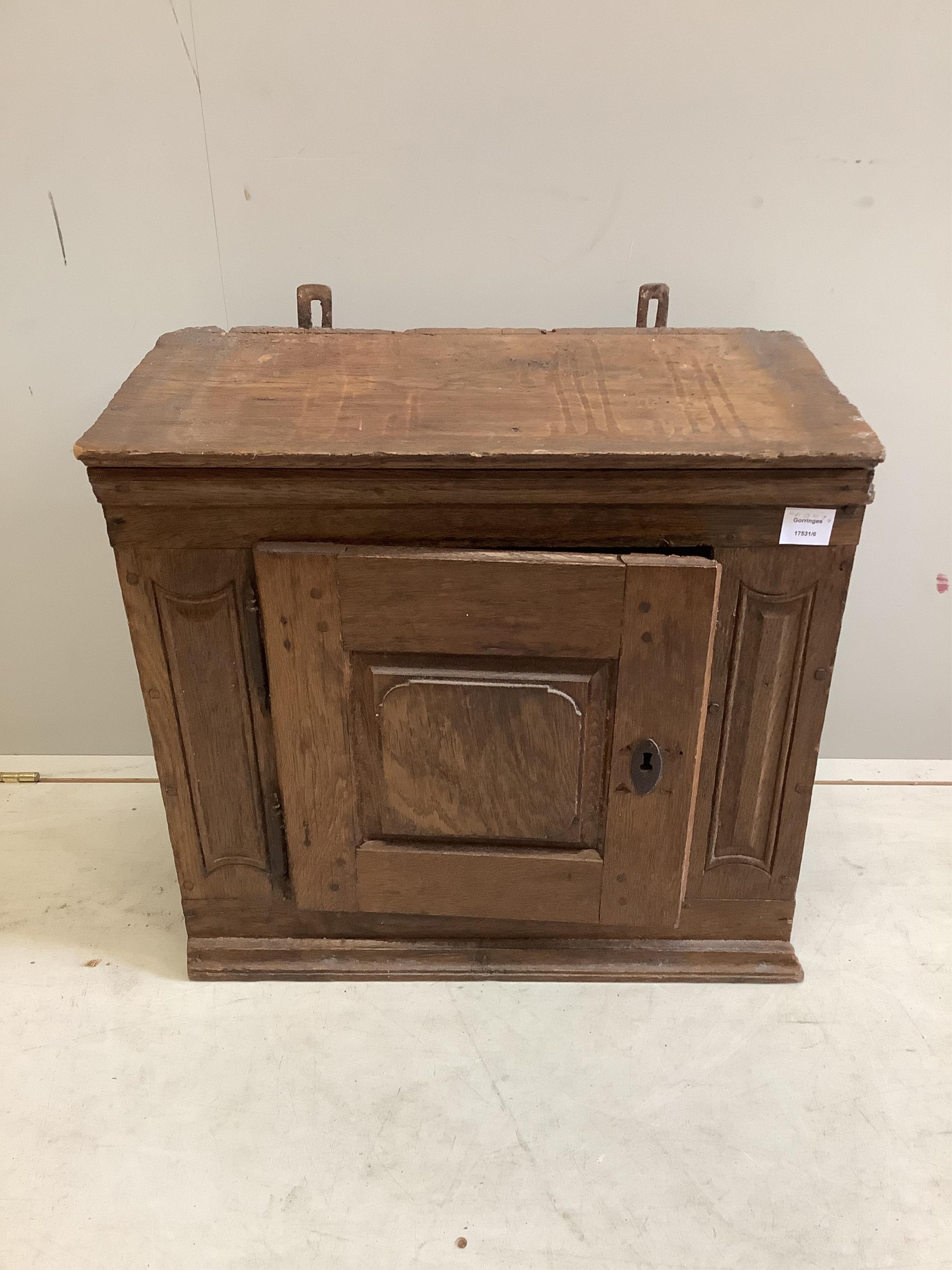 A small oak cupboard, width 61cm, depth 32cm, height 58cm